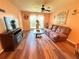 Inviting living room with wood floors, ceiling fan, and natural light from a large window at 2625 State Road 590 # 913, Clearwater, FL 33759