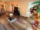 Open living space with wood floors and view into the kitchen at 2625 State Road 590 # 913, Clearwater, FL 33759