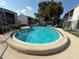 Community pool with lounge chairs and umbrellas offer residents a relaxing outdoor space at 2625 State Road 590 # 913, Clearwater, FL 33759