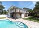 Exterior shot of the home with pool access from both first- and second-story balconies at 2807 57Th S St, Gulfport, FL 33707