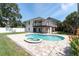 Exterior home view displaying private pool, brick paver patio, and wood balconies at 2807 57Th S St, Gulfport, FL 33707