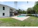 Beautiful backyard showcasing a pool, patio, and manicured lawn with palm trees at 2807 57Th S St, Gulfport, FL 33707