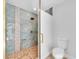 Chic bathroom with a blue tiled walk-in shower featuring upscale fixtures and a modern toilet at 2807 57Th S St, Gulfport, FL 33707