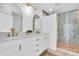 Elegant bathroom featuring double sinks, modern vanity, and a luxurious walk-in shower with blue marble accents at 2807 57Th S St, Gulfport, FL 33707