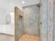 Luxurious bathroom featuring a walk-in shower with upscale fixtures and vanity in the background at 2807 57Th S St, Gulfport, FL 33707