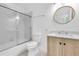 Clean bathroom features a shower-tub combination, modern vanity, and stylish round mirror at 2807 57Th S St, Gulfport, FL 33707