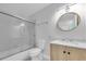 Clean bathroom features a shower-tub combination, modern vanity, and stylish round mirror at 2807 57Th S St, Gulfport, FL 33707