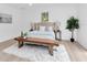 Comfortable bedroom featuring a king-sized bed, light wood floors, and a decorative wood bench at 2807 57Th S St, Gulfport, FL 33707