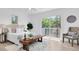 Bright bedroom with a king bed, a bench, and a sliding glass door to the outdoor deck at 2807 57Th S St, Gulfport, FL 33707