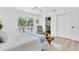 Well-lit bedroom featuring a king-sized bed, light wood floors, and a private entrance to the ensuite at 2807 57Th S St, Gulfport, FL 33707