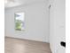 Minimalist bedroom with light-colored wood floors and a view of the outdoors at 2807 57Th S St, Gulfport, FL 33707