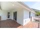Exterior of a home featuring a wood deck, glass sliding door, and white siding at 2807 57Th S St, Gulfport, FL 33707