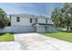Spacious two-story home featuring an attached garage and a long driveway at 2807 57Th S St, Gulfport, FL 33707