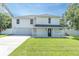 Inviting two-story home with a covered front porch and well-manicured lawn at 2807 57Th S St, Gulfport, FL 33707