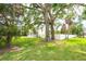 Well-maintained front yard with mature trees providing shade and enhancing the curb appeal of this inviting home at 2807 57Th S St, Gulfport, FL 33707
