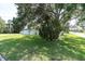Expansive front yard showcasing a lush lawn and established trees, creating a serene and inviting atmosphere at 2807 57Th S St, Gulfport, FL 33707