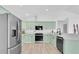 Kitchen featuring light green cabinets, stainless steel appliances, and white countertops at 2807 57Th S St, Gulfport, FL 33707