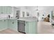 Light green cabinets, stainless steel appliances, and white countertop kitchen with view into living room at 2807 57Th S St, Gulfport, FL 33707