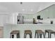 Inviting kitchen with light green cabinets, stainless steel refrigerator, and breakfast bar area at 2807 57Th S St, Gulfport, FL 33707