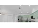 Charming kitchen featuring light green cabinets, stainless steel refrigerator, and a neutral countertop at 2807 57Th S St, Gulfport, FL 33707