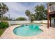 Private in-ground pool surrounded by a brick patio and white fence at 2807 57Th S St, Gulfport, FL 33707