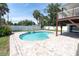 Backyard featuring a pool, brick paver patio, white fencing, and lush landscaping at 2807 57Th S St, Gulfport, FL 33707