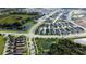 A high-angle aerial view showcases rows of modern homes, surrounded by ponds and greenery, in a suburban community at 28547 Hillcrest Valley Blvd, Wesley Chapel, FL 33543