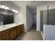 Modern bathroom with double sinks, a large mirror, and a glass-enclosed shower at 28547 Hillcrest Valley Blvd, Wesley Chapel, FL 33543