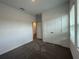 Clean bedroom with carpeted floors, closet and access to the bathroom at 28547 Hillcrest Valley Blvd, Wesley Chapel, FL 33543
