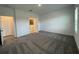 Comfortable bedroom with plush carpeting, a window, and access to the ensuite bathroom at 28547 Hillcrest Valley Blvd, Wesley Chapel, FL 33543