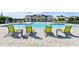 A stylish outdoor community pool is furnished with lounge chairs, umbrellas, and tables for resident enjoyment at 28547 Hillcrest Valley Blvd, Wesley Chapel, FL 33543