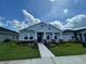 A beautifully landscaped single-Gathering home with a welcoming entryway and lush green lawn under a bright blue sky at 28547 Hillcrest Valley Blvd, Wesley Chapel, FL 33543