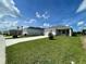 Beautiful single-Gathering home featuring a well-manicured lawn and private driveway under a sunny blue sky at 28547 Hillcrest Valley Blvd, Wesley Chapel, FL 33543