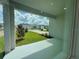 Inviting covered porch area overlooking a lush green lawn and neighborhood street at 28547 Hillcrest Valley Blvd, Wesley Chapel, FL 33543
