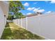 Backyard view with a white fence and pergola, creating a serene outdoor space at 2907 W Tyson Ave, Tampa, FL 33611