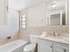 Tiled bathroom featuring bathtub, toilet and vanity with granite countertop at 2907 W Tyson Ave, Tampa, FL 33611