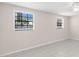Bright, minimalist bedroom with tile floors, neutral paint and large windows with view of the outside at 2907 W Tyson Ave, Tampa, FL 33611