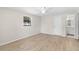 Light bedroom with wood flooring, ceiling fan and a view into the bright bathroom at 2907 W Tyson Ave, Tampa, FL 33611