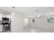 Open concept living area with white cabinets and stainless appliances in an attached kitchenette space at 2907 W Tyson Ave, Tampa, FL 33611