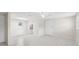 Bright and open living space with neutral walls, tile floors, and access to a small modern kitchen at 2907 W Tyson Ave, Tampa, FL 33611