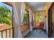 Relaxing covered balcony with a comfortable chair and views of lush greenery, creating a peaceful retreat at 3112 W Wallcraft Ave, Tampa, FL 33611