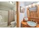 Bright bathroom featuring a vessel sink, wooden cabinetry, a mirror, and a combination bathtub and shower at 3112 W Wallcraft Ave, Tampa, FL 33611