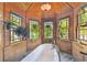 This stunning bathroom features a soaking tub surrounded by windows and wood walls at 3112 W Wallcraft Ave, Tampa, FL 33611