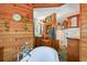 Open bathroom concept featuring wood floors, a soaking tub, and custom cabinetry at 3112 W Wallcraft Ave, Tampa, FL 33611