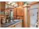 Charming bathroom vanity featuring natural wood cabinets and granite counters with a glass enclosed tiled shower at 3112 W Wallcraft Ave, Tampa, FL 33611