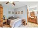Comfortable bedroom featuring a ceiling fan, wood flooring, and an adjacent bathroom with an artistic decor at 3112 W Wallcraft Ave, Tampa, FL 33611