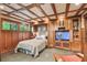 Guest bedroom featuring custom wood paneling, built in cabinets, and a comfortable queen sized Murphy bed at 3112 W Wallcraft Ave, Tampa, FL 33611