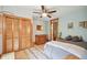 This bedroom features wood floors, a ceiling fan, and lots of closet space at 3112 W Wallcraft Ave, Tampa, FL 33611