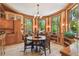 Inviting dining room featuring a round table, wooden floors and natural light from the large windows at 3112 W Wallcraft Ave, Tampa, FL 33611