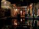 Reflections of a home's exterior at night are highlighted in a beautiful pool at 3112 W Wallcraft Ave, Tampa, FL 33611